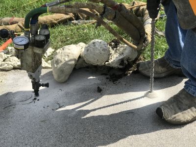 How Commercial Concrete Mudjacking Restores Uneven Surfaces